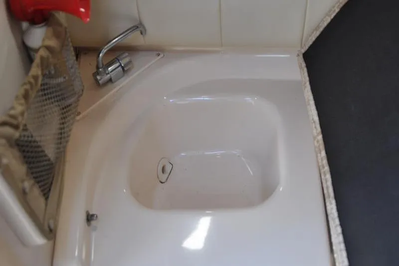 Slide: The Image of 2007 Grady-White Seafarer 226 boat sink with faucet and storage net. - 33