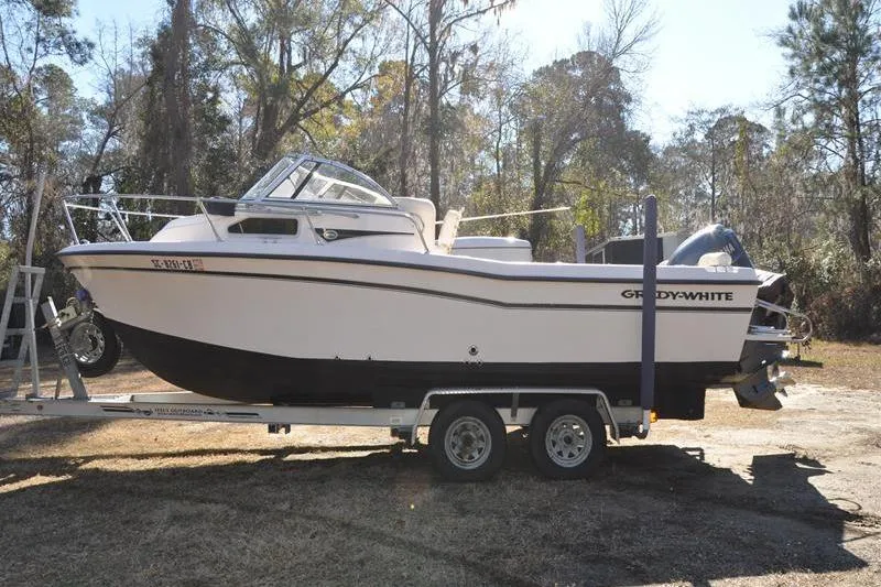 Slide: The Image of 2007 Grady-White Seafarer 226 boat on trailer in wooded area. - 5