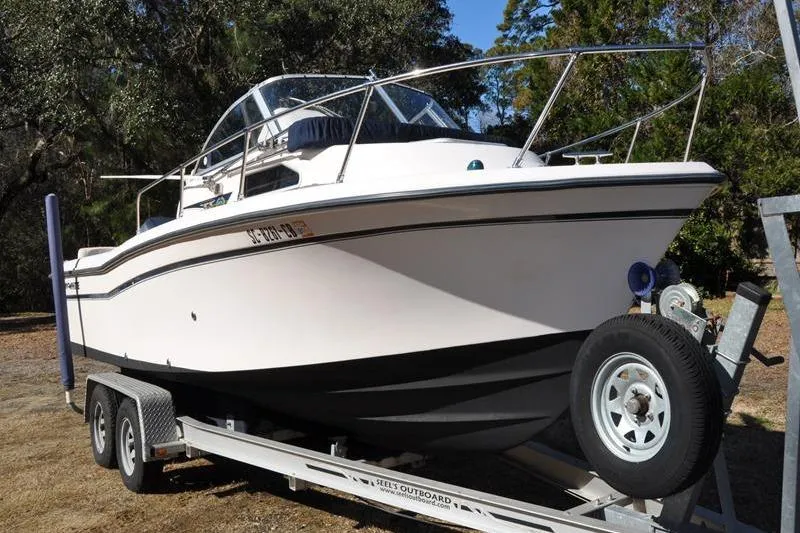 Slide: The Image of 2007 Grady-White Seafarer 226 boat on trailer, parked outdoors. - 7