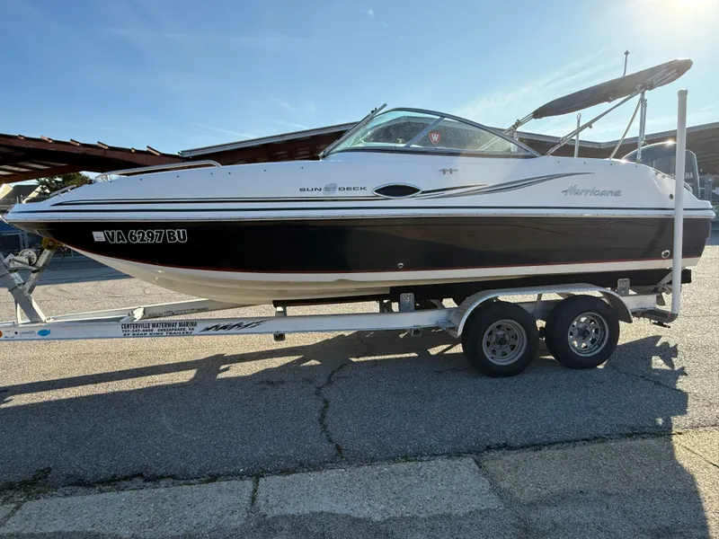 Slide: The Image of 2013 Hurricane 217 SunDeck OB on trailer outdoors. - 2