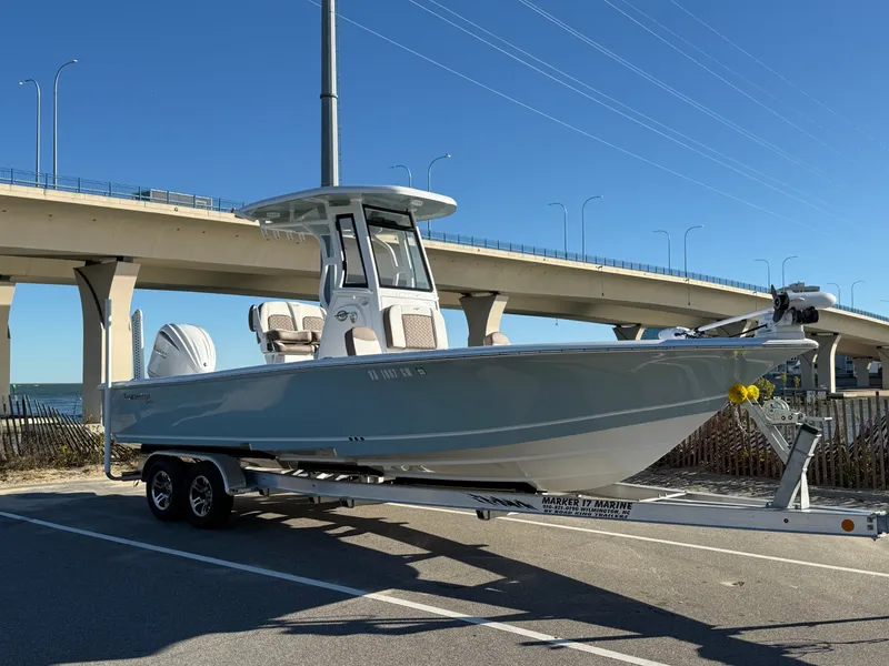 The Image of 2024 Tidewater 2500 Carolina Bay Custom boat on trailer under bridge. - 0
