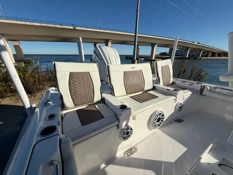 Slide: The Image of 2024 Tidewater 2500 Carolina Bay Custom boat by water under bridge. - 14