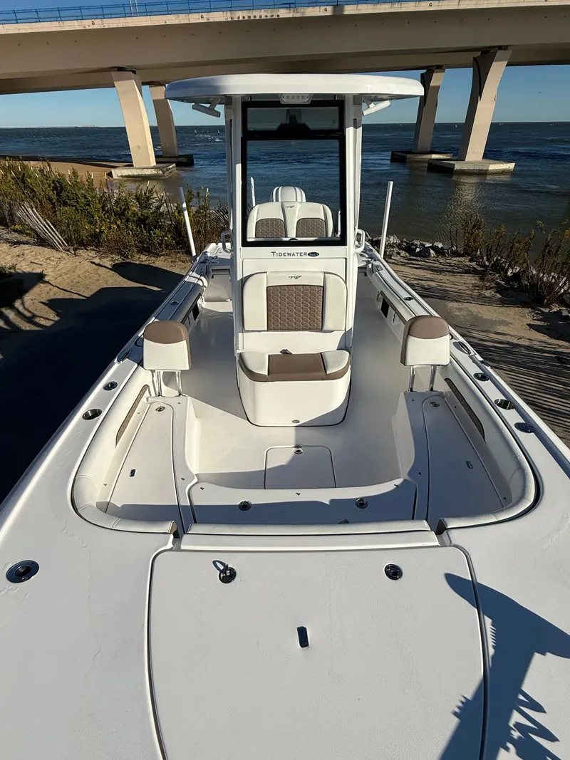 Slide: The Image of 2024 Tidewater 2500 Carolina Bay Custom boat by water under bridge. - 8