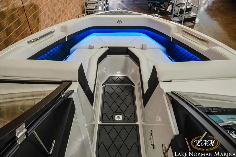 Slide: The Image of Luxurious interior of 2026 Cobalt R4 boat with blue LED lighting and cushioned seating. - 13