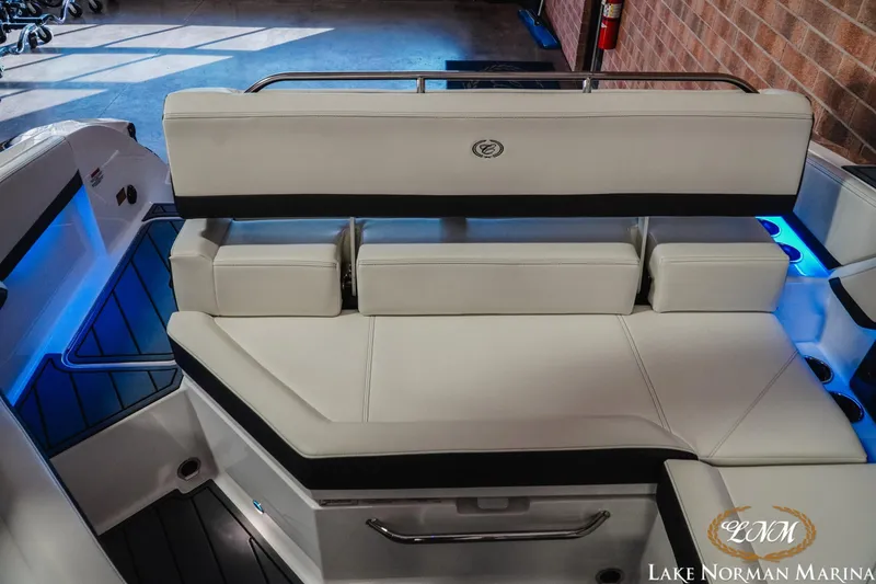 Slide: The Image of 2026 Cobalt R4 boat interior with white seating and blue LED lighting at Lake Norman Marina. - 19