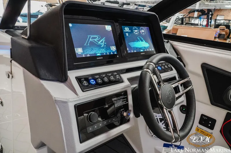 Slide: The Image of 2026 Cobalt R4 boat dashboard with advanced Garmin navigation system and sleek steering wheel. - 21