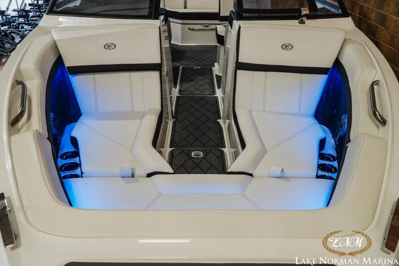 Slide: The Image of 2026 Cobalt R4 boat interior with white seating and blue LED lighting at Lake Norman Marina. - 3