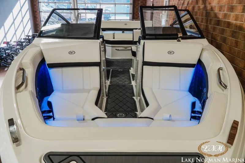 Slide: The Image of 2026 Cobalt R4 boat interior with white seating and blue accent lighting at Lake Norman Marina. - 4