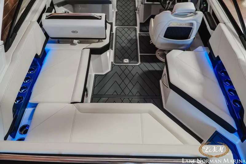 Slide: The Image of Luxurious interior of 2026 Cobalt R4 boat with white seating and blue LED lighting. - 8