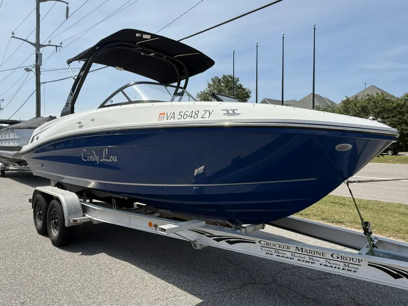 The Image of 2023 Bayliner VR6 boat on trailer, blue and white design. - 0