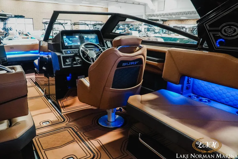 Slide: The Image of Interior of 2026 Cobalt R8 Surf boat with modern dashboard and ambient lighting. - 10