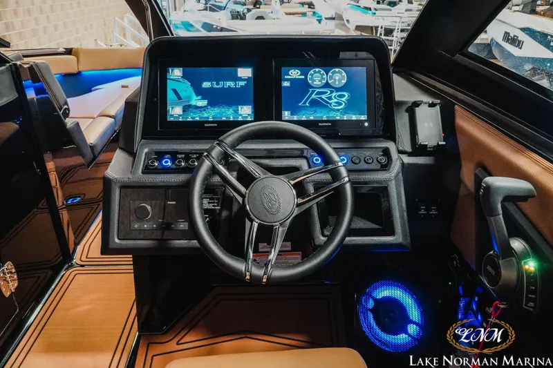 Slide: The Image of 2026 Cobalt R8 Surf boat dashboard with advanced controls and digital displays at Lake Norman Marina. - 13