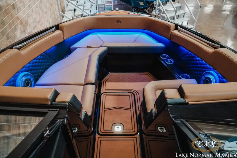 Slide: The Image of Luxurious interior of 2026 Cobalt R8 Surf boat with ambient blue lighting and plush seating. - 16