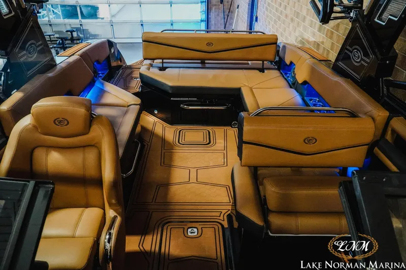 Slide: The Image of Luxurious interior of 2026 Cobalt R8 Surf boat with tan leather seating and ambient lighting. - 18