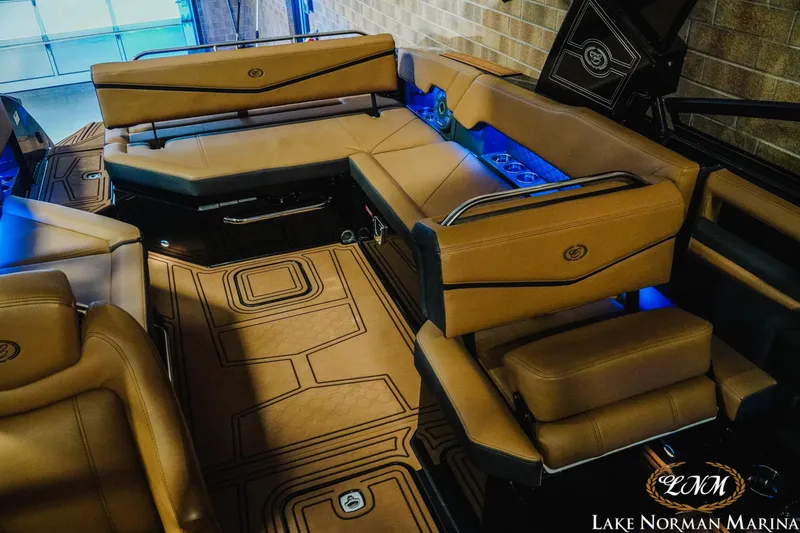 Slide: The Image of Luxurious interior of 2026 Cobalt R8 Surf boat with tan seating and blue LED lighting. - 19