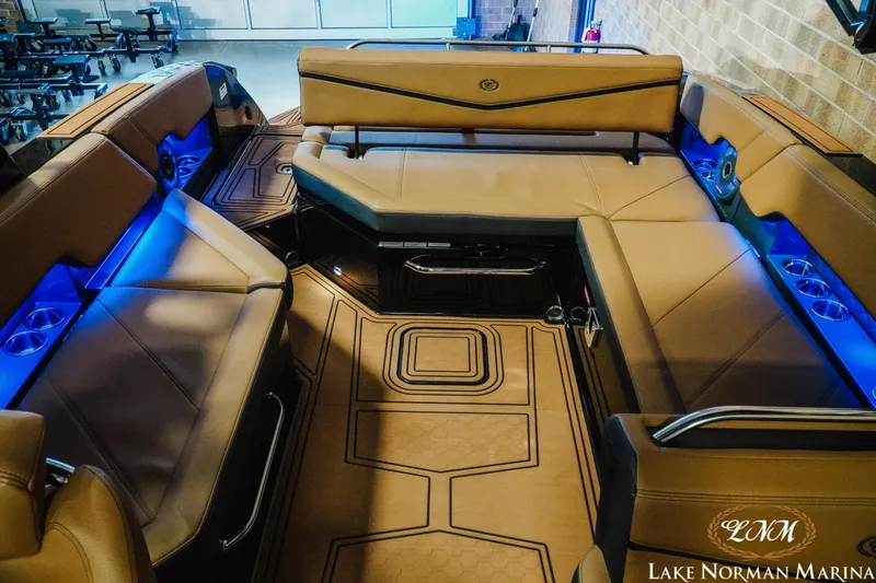 Slide: The Image of Luxurious interior of 2026 Cobalt R8 Surf boat with blue LED lighting and tan seating. - 20