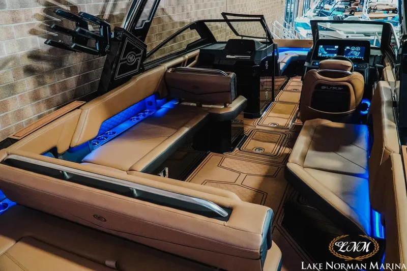 Slide: The Image of 2026 Cobalt R8 Surf boat interior with luxurious seating and ambient blue lighting at Lake Norman Marina. - 8