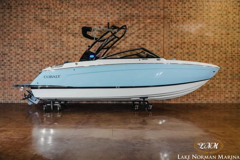 The Image of 2026 Cobalt R6 boat in showroom, light blue and white design, displayed at Lake Norman Marina. - 0