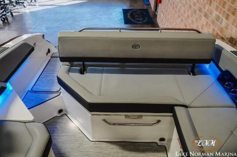 Slide: The Image of 2026 Cobalt R6 boat interior with gray seating and blue accent lighting at Lake Norman Marina. - 2