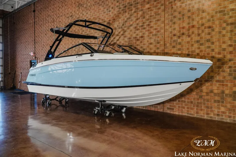 Slide: The Image of 2026 Cobalt R6 boat in showroom, light blue and white design, Lake Norman Marina. - 5