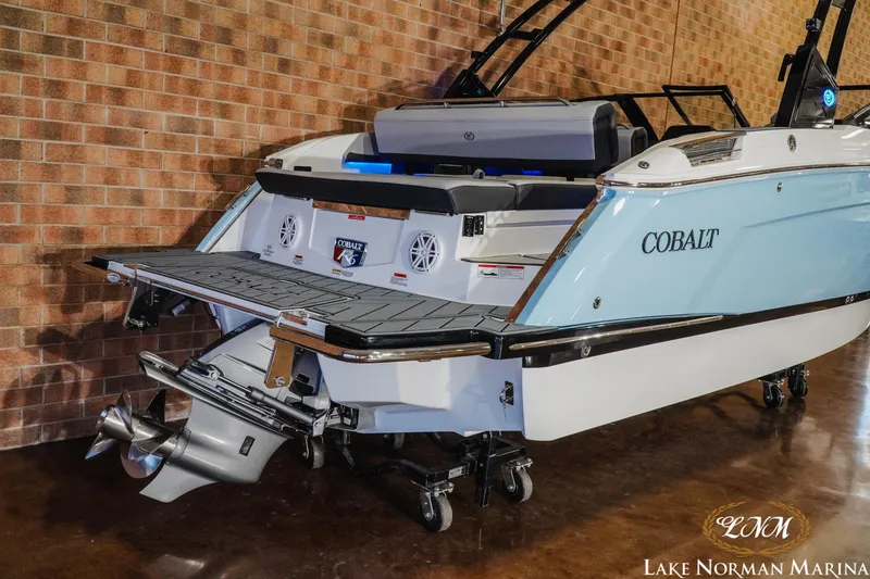 Slide: The Image of 2026 Cobalt R6 boat with swim platform, displayed indoors at Lake Norman Marina. - 9