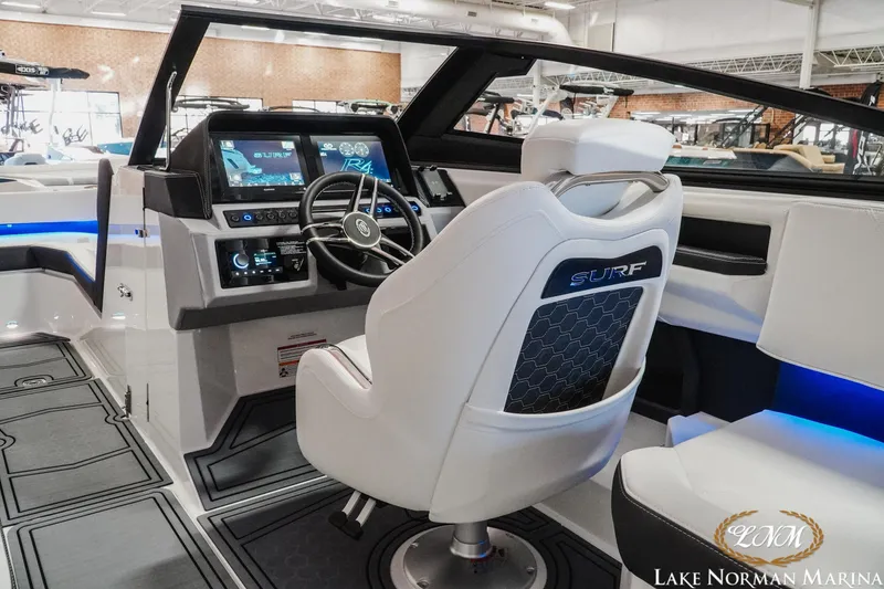 Slide: The Image of 2026 Cobalt R4 Surf boat interior with modern dashboard and steering wheel at Lake Norman Marina. - 16