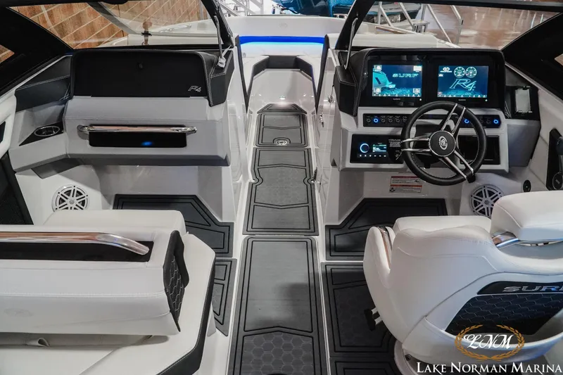Slide: The Image of 2026 Cobalt R4 Surf boat interior with advanced dashboard and steering wheel at Lake Norman Marina. - 18