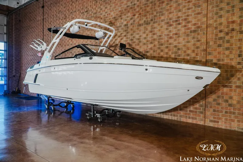 Slide: The Image of 2026 Cobalt R4 Surf boat displayed indoors at Lake Norman Marina. - 2