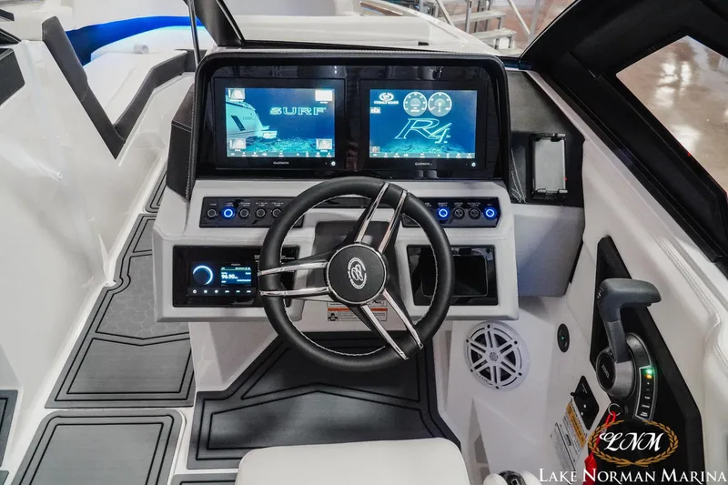 Slide: The Image of 2026 Cobalt R4 Surf boat dashboard with advanced controls and dual display screens. - 20