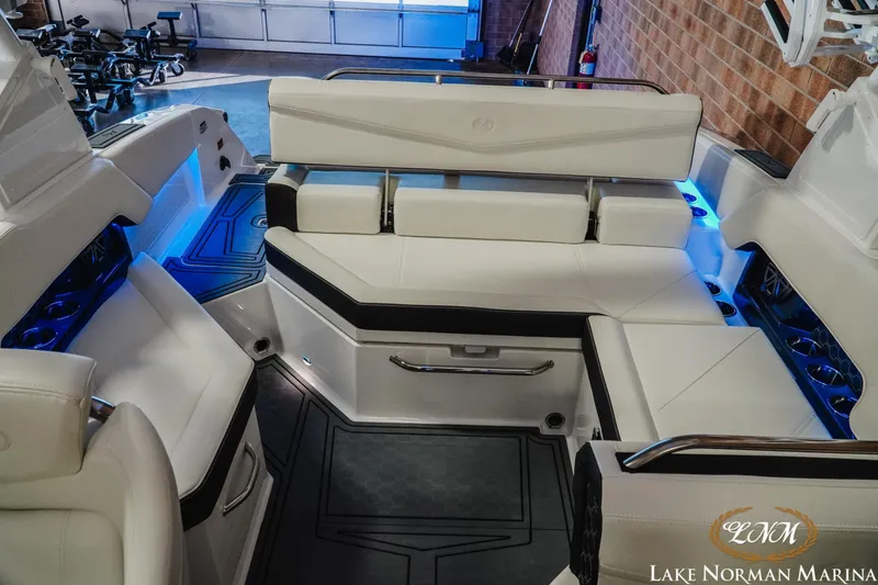 Slide: The Image of 2026 Cobalt R4 Surf boat interior with white seating and blue LED lighting. - 4
