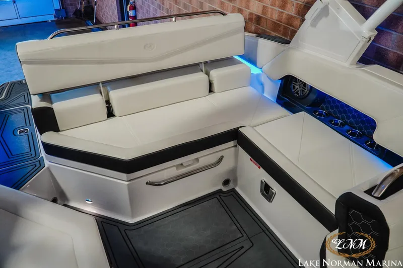 Slide: The Image of 2026 Cobalt R4 Surf boat interior with white seating and blue LED lighting. - 5