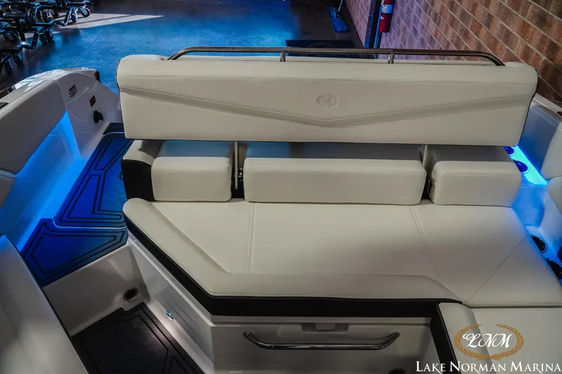 Slide: The Image of 2026 Cobalt R4 Surf boat interior with white seating and blue LED lighting. - 6