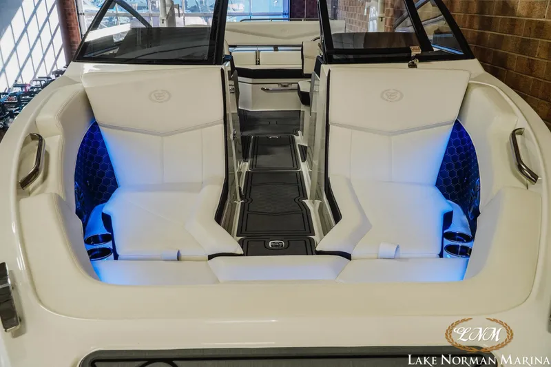 Slide: The Image of 2026 Cobalt R4 Surf boat interior with white seating and blue LED lighting. - 9