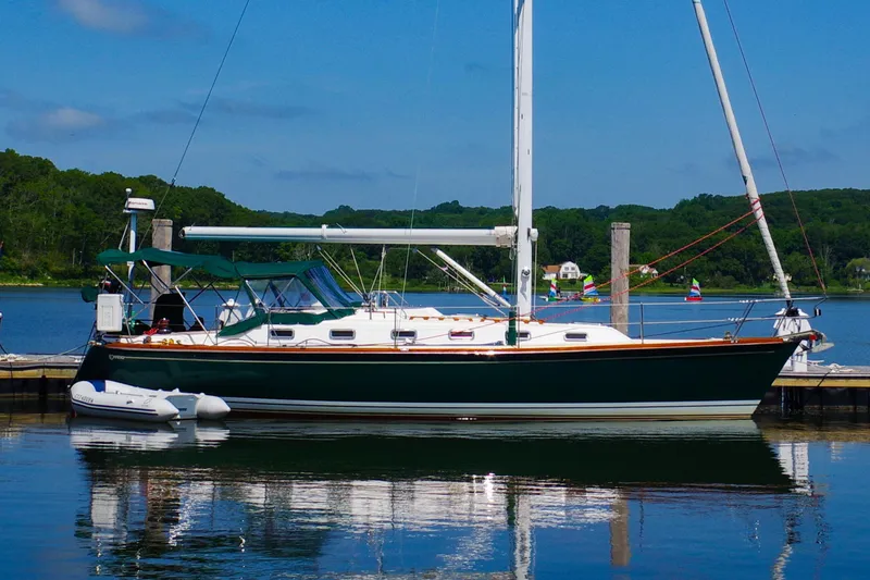 The Image of Sailboat Tartan 4100, 2001 model, docked in a serene marina setting. - 0