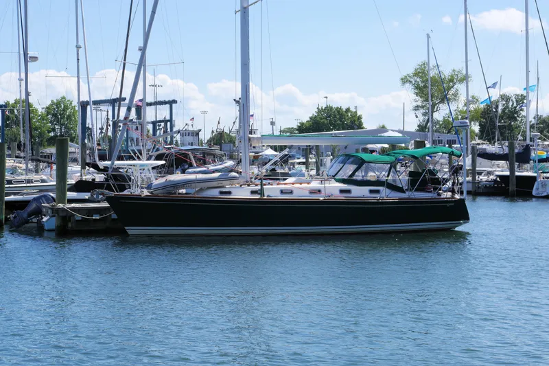 Slide: The Image of Sailboat Tartan 4100, 2001 model, docked in a marina under clear skies. - 1