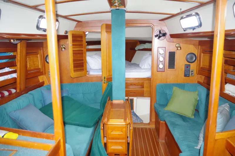 Slide: The Image of Interior of 2001 Tartan 4100 sailboat with cozy seating and wooden finishes. - 12