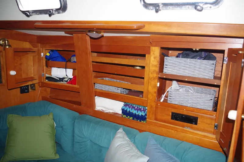Slide: The Image of Interior of 2001 Tartan 4100 sailboat with wooden cabinets and cozy seating area. - 15
