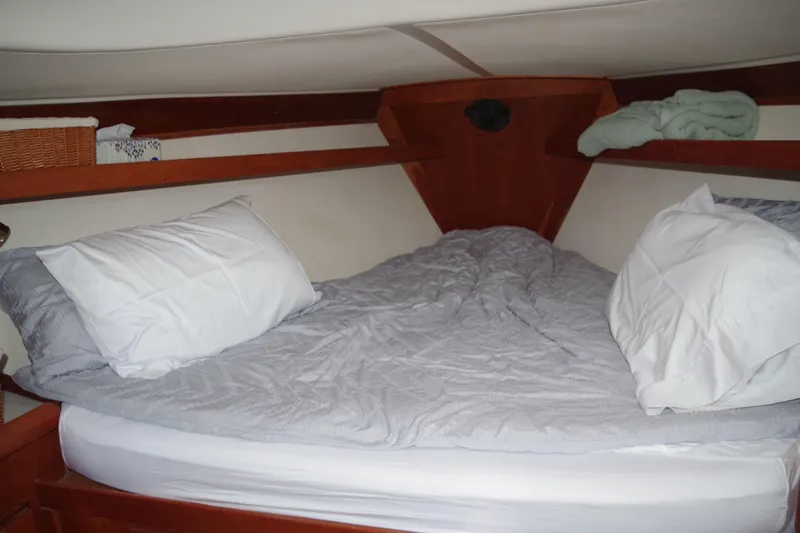 Slide: The Image of Cozy cabin bed in 2001 Tartan 4100 sailboat with pillows and blanket. - 20