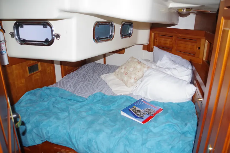 Slide: The Image of Cozy cabin interior of 2001 Tartan 4100 sailboat with bed and portholes. - 21