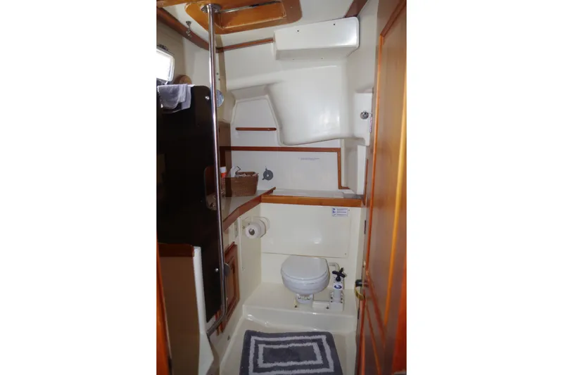 Slide: The Image of Interior of 2001 Tartan 4100 sailboat bathroom with toilet and storage. - 22