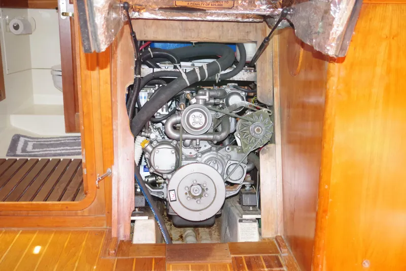 Slide: The Image of Engine compartment of a 2001 Tartan 4100 sailboat, showcasing detailed mechanical components. - 24
