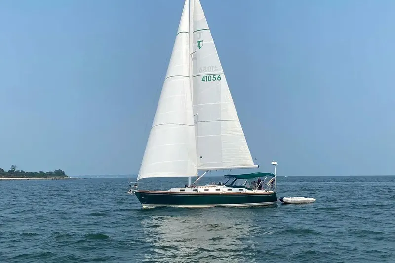 Slide: The Image of Sailing yacht Tartan 4100 from 2001 on open water under clear skies. - 30