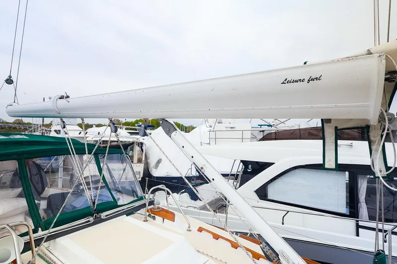 Slide: The Image of Sailboat Tartan 4100, 2001 model, featuring a Leisure Furl boom in a marina setting. - 32
