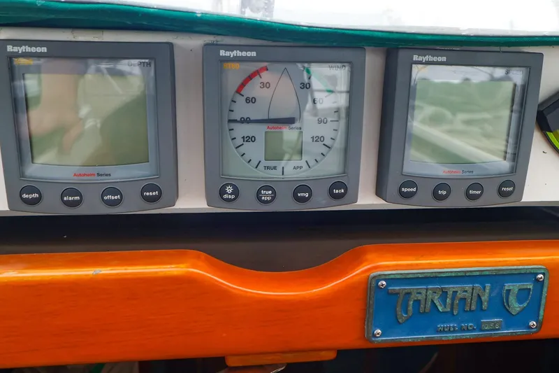 Slide: The Image of Raytheon navigation instruments on a 2001 Tartan 4100 yacht dashboard. - 33