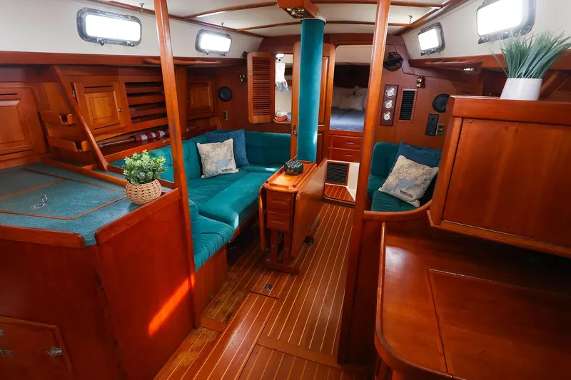 Slide: The Image of Luxurious 2001 Tartan 4100 yacht interior with rich wood finish and teal seating. - 34
