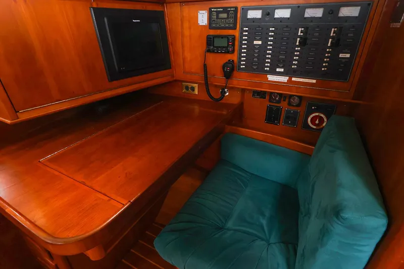 Slide: The Image of Navigation station in 2001 Tartan 4100 yacht with control panel and cushioned seat. - 35