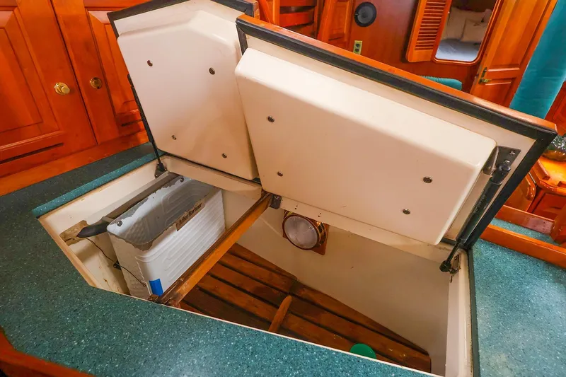 Slide: The Image of Open hatch in 2001 Tartan 4100 yacht interior, revealing storage space and wooden flooring. - 37