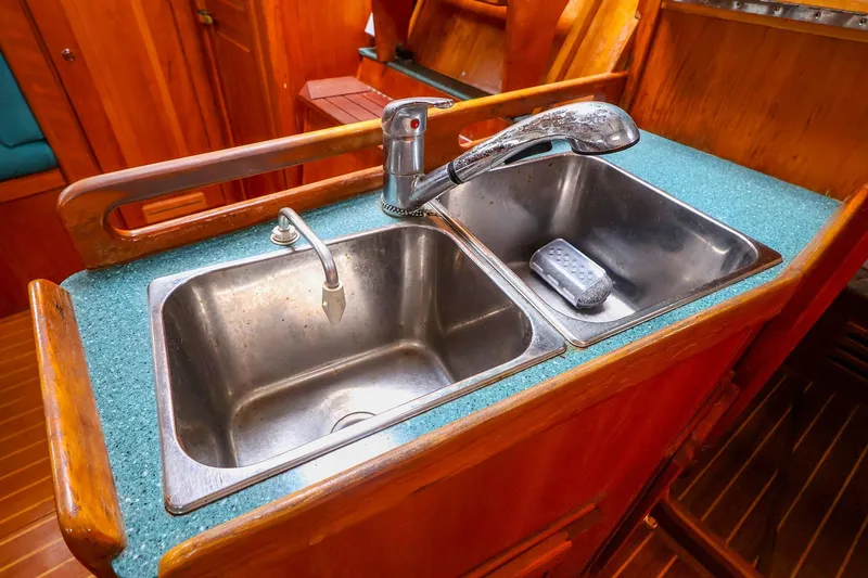 Slide: The Image of Stainless steel double sink in 2001 Tartan 4100 yacht galley with wooden cabinetry. - 38