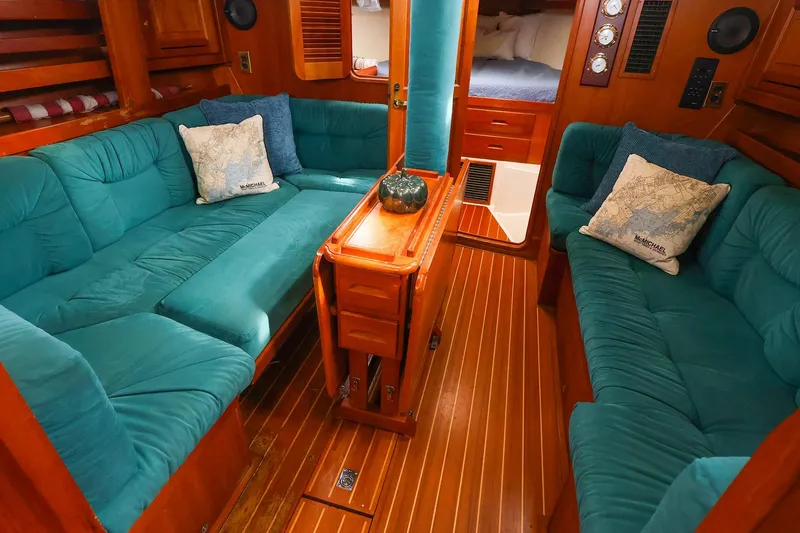 Slide: The Image of Luxurious 2001 Tartan 4100 yacht interior with teal seating and wooden accents. - 41