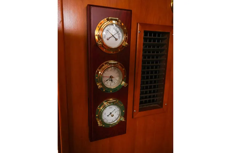 Slide: The Image of Wooden panel with three brass nautical gauges on a 2001 Tartan 4100 yacht. - 42